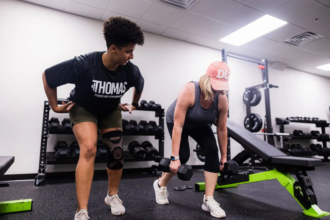 Coach guiding a client through a strength training session at Thomas Fitness and Performance in Farmington, CT